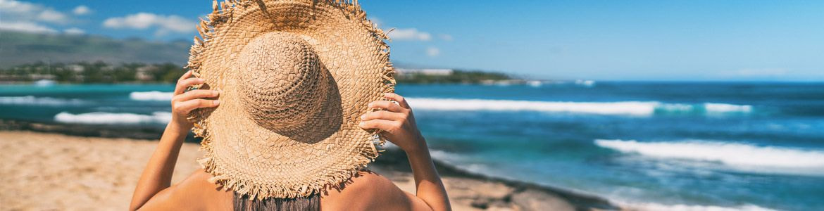 donna con cappello sulla spiaggia di Maiorca