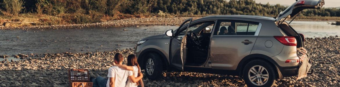 casal a fazer piquenique com um automóvel SUV